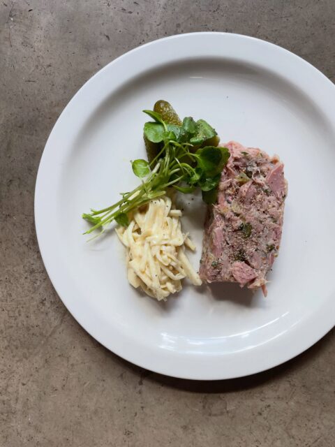 Pressed local ham hock, slow-cooked in cider, served with celeriac rémoulade, cornichons and watercress.